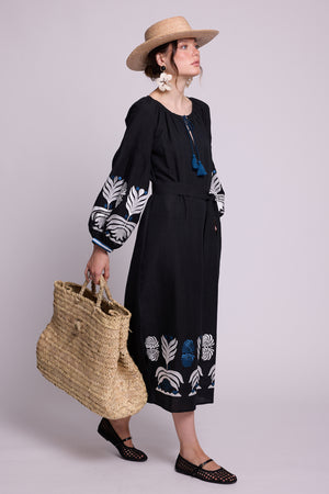 Full-length front view of model wearing the KLEED Portofino Black Kaftan with embroidered cuffs and hem.