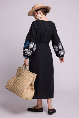 Back view of model wearing the KLEED Portofino Black Kaftan, showing its relaxed long silhouette and embroidered sleeves.