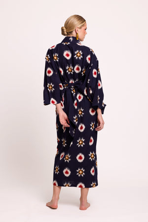 Back view of woman wearing Kleed Sushi Kimono in handloomed Ikat cotton navy blue geometric pattern in red yellow and white