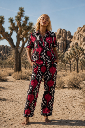 Editprial photo of model wearing read yala pyjama in the desert in bear foot. by Kleed.